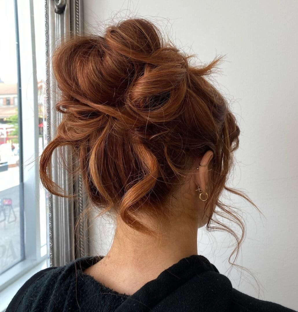 Tousled copper-red updo with loose tendrils — Salon Fiorella