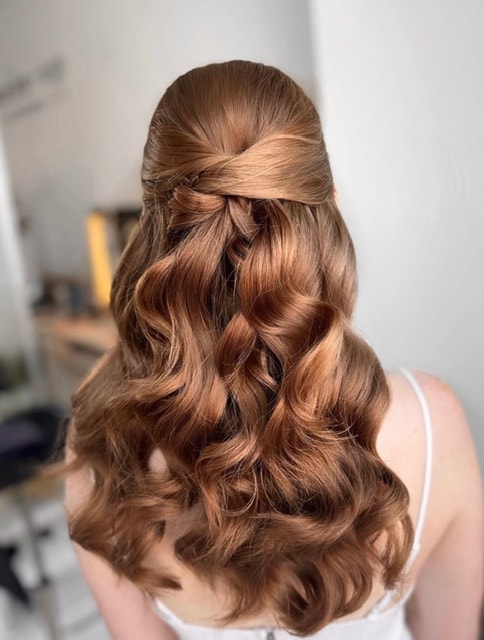 Elegant updo with sculptural teal fascinator — Salon Fiorella